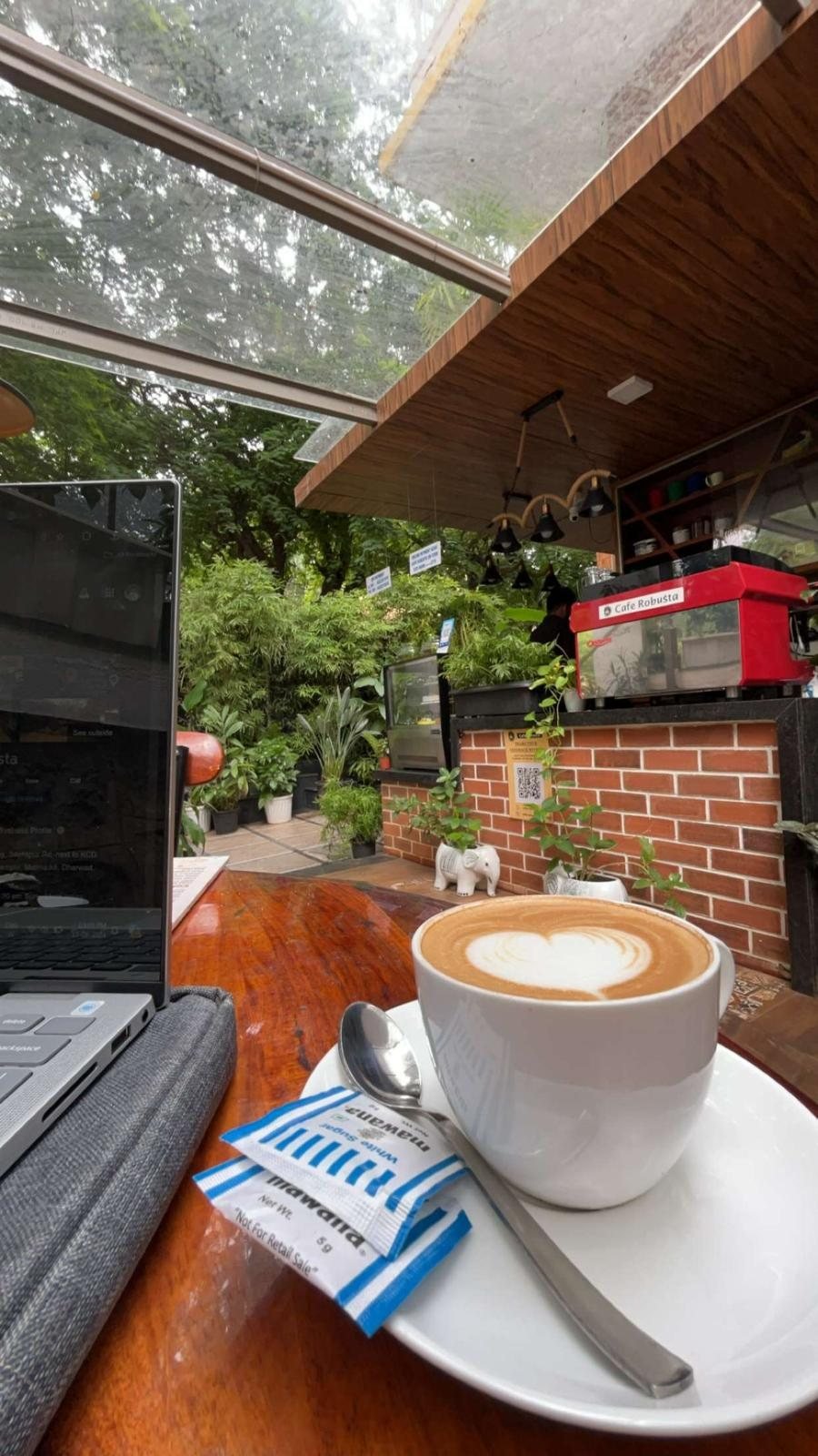 Coffee and a laptop under the glass roof